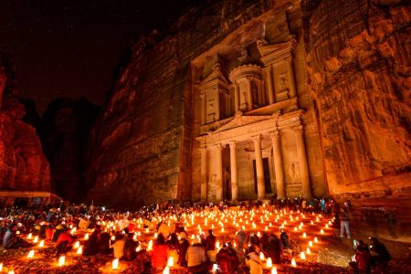 Al Khazneh in the ancient city of Petra, Jordan at night. It is known as The Treasury. Petra has led to its designation as a UNESCO World Heritage Site.